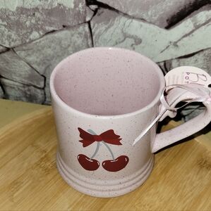 Pink Speckled Mug withCherry And Bow Design.